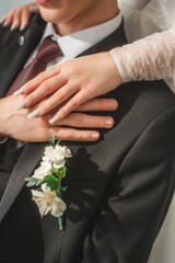 Details of bride and groom hugging at wedding day