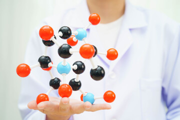 Scientist holding molecular model for chemical technology.
