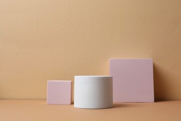 Various podiums with smooth, textured surface under soft tones. Ideal for product mockups, cosmetic displays, or minimal brand presentations. 3D rendering