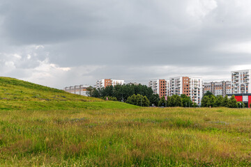 Obraz premium Modern Residential Buildings Near Green Meadow