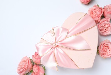 Beautiful composition with pink roses and gift box on white background. Ideal for Valentine's Day, 8 March, Birthday or other holidays