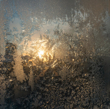 The view of the winter sun through frost patterns on the glass