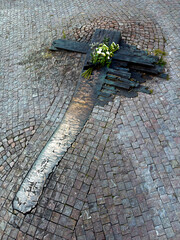 A cross in the pavement of Wenceslas Square.