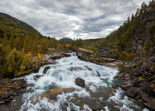 view of the picturesque Brufossen waterfall in the Rauma valley near Verma in central Norway