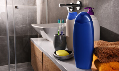 Plastic bottles of body care and beauty products in the bathroom