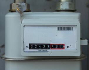 A white gas meter showing the index expressed in m³. The display shows five black digits for whole units and three red digits for decimals, all clearly visible in the image.