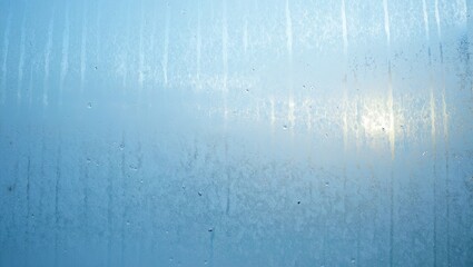 A soft frosted glass texture with vertical streaks creates a cold subtle abstract background suitable for modern design projects. Generative AI.