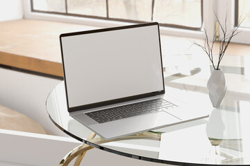 Blank Screen Laptop on Glass Desk with Natural Light