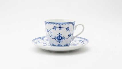 Delicate teacup and saucer with blue floral patterns against white