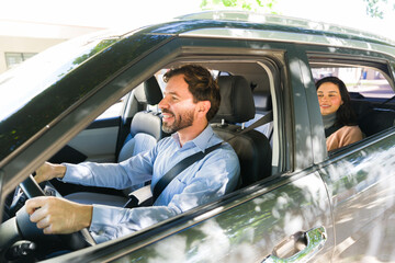 Rideshare driver transporting female passenger in car, providing convenient urban transportation service © AntonioDiaz