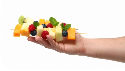 Hand Holding Fresh Fruit Skewers With Cantaloupe Melon Honeydew Kiwi Blueberry Raspberry Mint Isolated On White Background Studio Shot