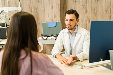 Optometrist talking with patient about vision care and eye health during a medical consultation