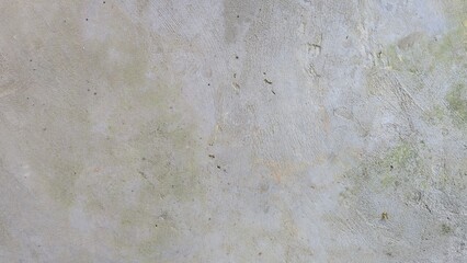 The gray floor is stained and scratched. An old, weathered concrete floor or cement surface with signs of age and use. Features green moss patches and earthy tones. Ideal for grunge.