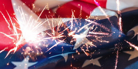 Fireworks light up the night sky above the American flag during a celebration event in July