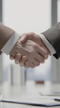Business Partners Making Agreement with Handshake in Modern Office Setting