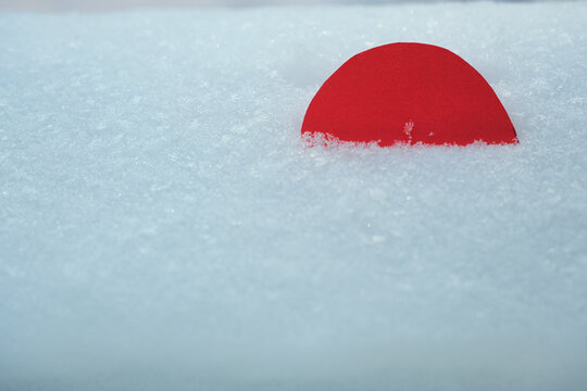 Minimalistic image of Greenland flag element on snowy space. Geopolitical interests in the Arctic region. Abstract political and economic concept.