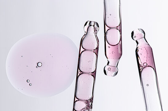 Skin serum in a pipette. A cosmetic product for body care. White background.