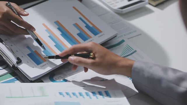 Asian male financial officer or accountant checking investment results Financial budget analysis Planning to summarize results and report to the meeting Audit concept and investment results.