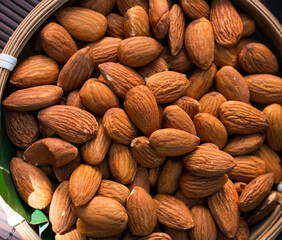 Fototapeta premium Close up of roasted almonds filling a woven basket