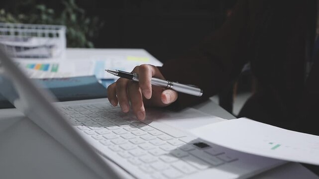 Asian male financial officer or accountant checking investment results Financial budget analysis Planning to summarize results and report to the meeting Audit concept and investment results.