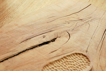 Wood surface with visible grain crack and carved texture found in workshop space