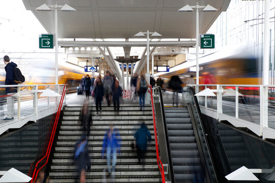 Long exposure image of people at a train station , Holland