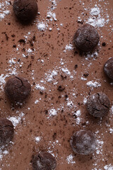 Homemade chocolate chip cookie or biscuit on brown background top view.
