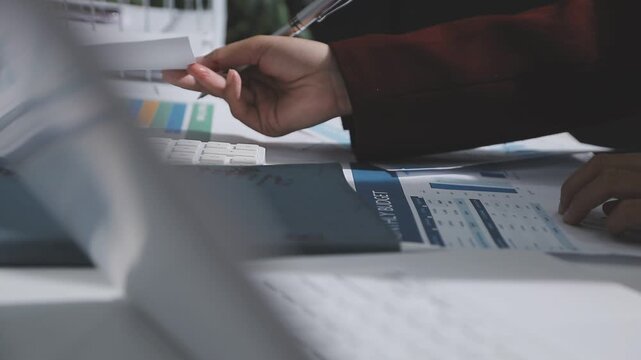 Asian male financial officer or accountant checking investment results Financial budget analysis Planning to summarize results and report to the meeting Audit concept and investment results.