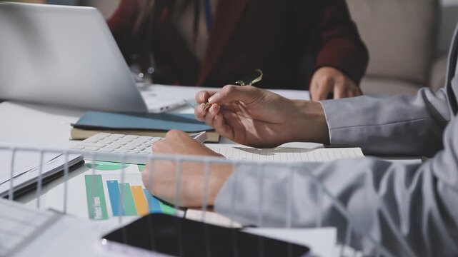 Asian male financial officer or accountant checking investment results Financial budget analysis Planning to summarize results and report to the meeting Audit concept and investment results.