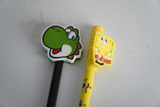 Yoshi and Spongebob pencil toppers on writing utensils for kids