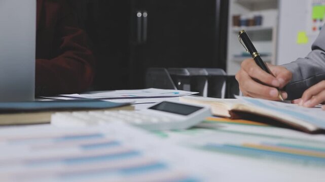 Asian male financial officer or accountant checking investment results Financial budget analysis Planning to summarize results and report to the meeting Audit concept and investment results.