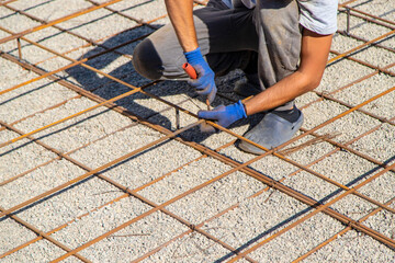 Knitting metal reinforcement for a swimming pool. Selective focus.