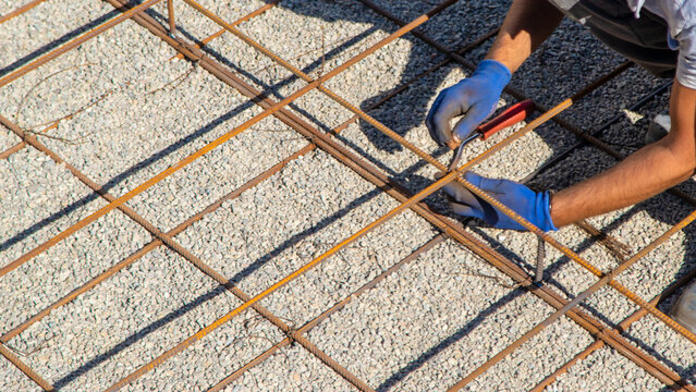 Knitting metal reinforcement for a swimming pool. Selective focus.