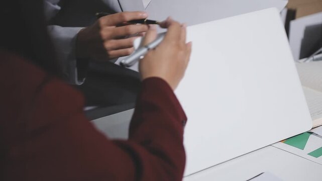 Asian male financial officer or accountant checking investment results Financial budget analysis Planning to summarize results and report to the meeting Audit concept and investment results.