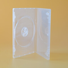 Blank CD case or CD cover on color background.