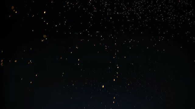Dark expanse with glowing specks seemingly falling or floating, creating a dreamy, cosmic effect