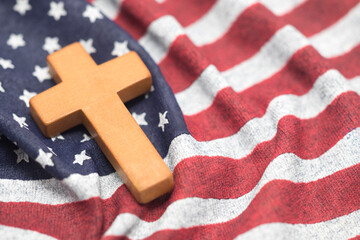 Wooden cross on wavy American flag