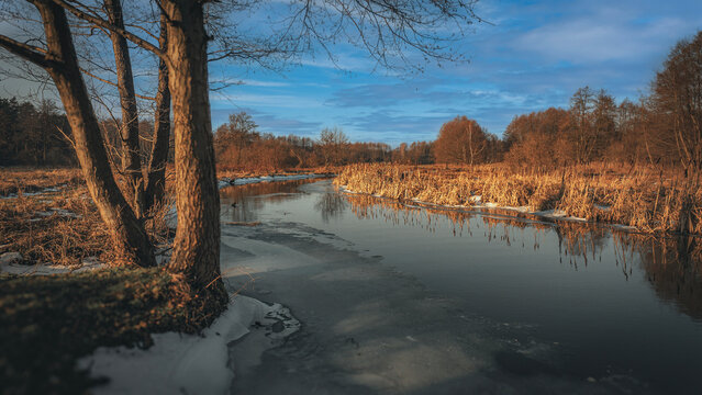 Winter and snow on the small Grabia River, Poland.