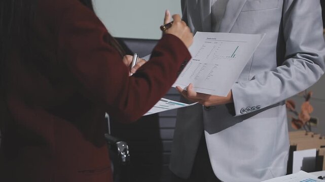 Asian male financial officer or accountant checking investment results Financial budget analysis Planning to summarize results and report to the meeting Audit concept and investment results.