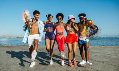 Friends group dancing on boardwalk during carnival