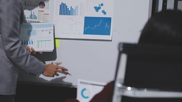 Asian male financial officer or accountant checking investment results Financial budget analysis Planning to summarize results and report to the meeting Audit concept and investment results.