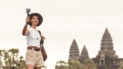 Young Backpacker Filming Angkor Wat For Her Travel Vlog In Cambodia