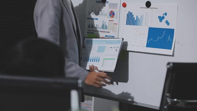 Asian male financial officer or accountant checking investment results Financial budget analysis Planning to summarize results and report to the meeting Audit concept and investment results.