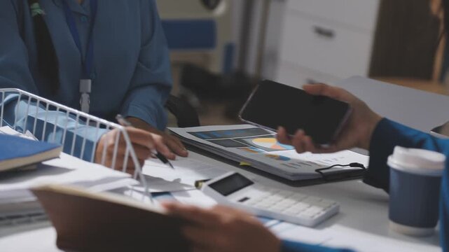 Asian male financial officer or accountant checking investment results Financial budget analysis Planning to summarize results and report to the meeting Audit concept and investment results.