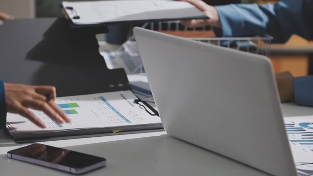 Asian male financial officer or accountant checking investment results Financial budget analysis Planning to summarize results and report to the meeting Audit concept and investment results.