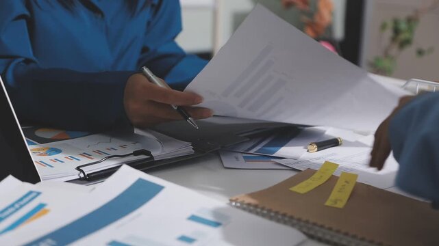 Asian male financial officer or accountant checking investment results Financial budget analysis Planning to summarize results and report to the meeting Audit concept and investment results.
