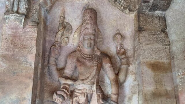 Majestic Lord Vishnu sculpture from Badami Cave No. 3, carved in red sandstone, depicting divine grace, intricate ornaments, and superb Chalukyan artistry from the 6th&ndash;7th century