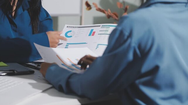 Asian male financial officer or accountant checking investment results Financial budget analysis Planning to summarize results and report to the meeting Audit concept and investment results.