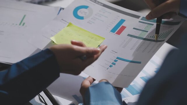 Asian male financial officer or accountant checking investment results Financial budget analysis Planning to summarize results and report to the meeting Audit concept and investment results.