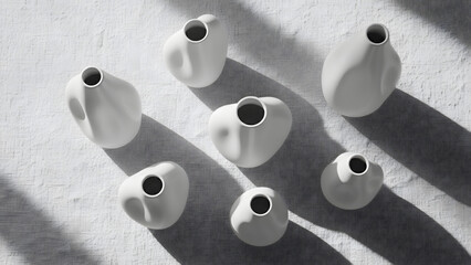 Set of seven modern white ceramic vases on textured surface